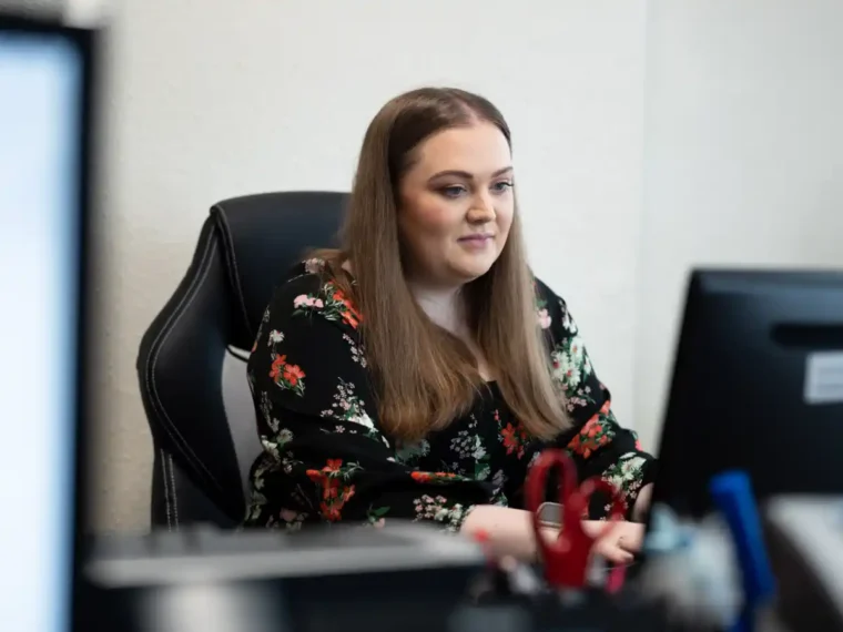 Photo of Gemma working at a desk - CIS Support from PMP Accounts